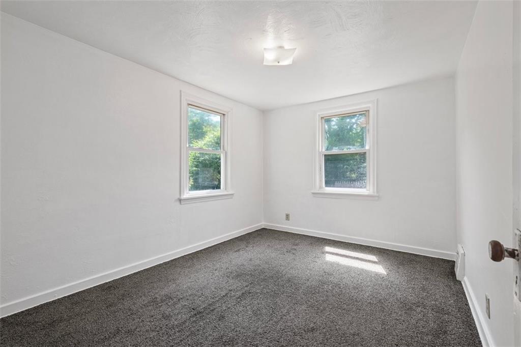 1012 Universal Road Pittsburgh, PA 15235 - Photo 5 of 13 an empty room with windows and closet