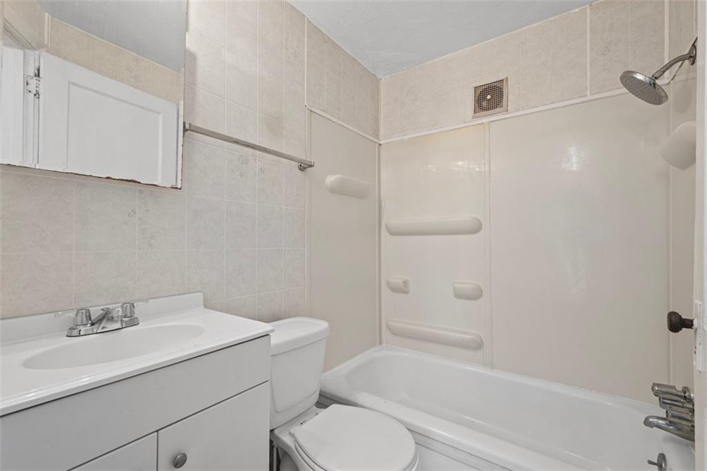 1012 Universal Road Pittsburgh, PA 15235 - Photo 6 of 13 a bathroom with a sink toilet and shower