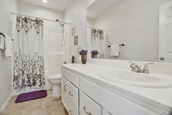 a bathroom with double sink and a mirror