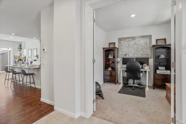 a kitchen with kitchen island granite countertop a sink and cabinets