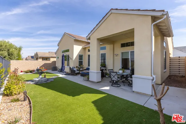 a view of a house with backyard porch and sitting area