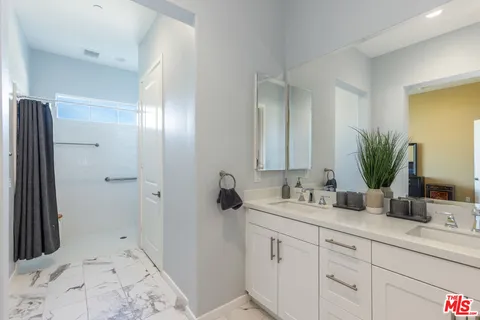 a bathroom with a double vanity sink and mirror