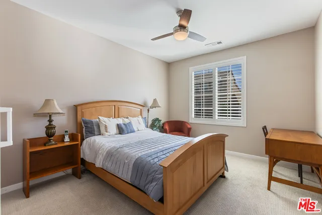 a bedroom with a bed a chair and a couch