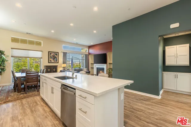 a open kitchen with stainless steel appliances granite countertop a sink and dishwasher with wooden floor