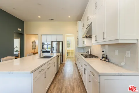 a kitchen with stainless steel appliances granite countertop a sink and cabinets
