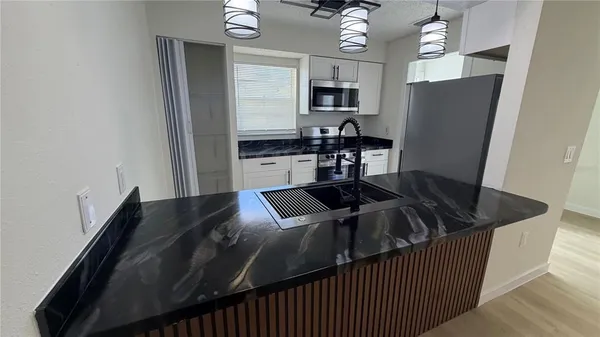 a kitchen with a kitchen island a stove and a refrigerator