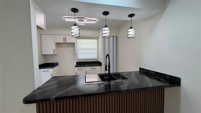 a large room with kitchen view