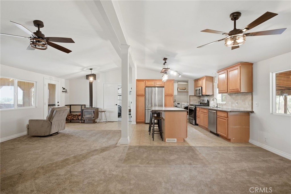 40100 Owl Valley Road Temecula, CA 92592 - Photo 23 of 44 a living room with furniture and a kitchen