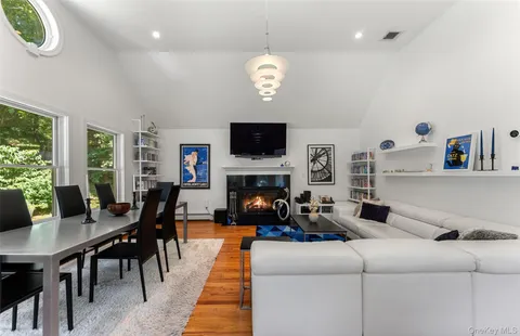 a living room with furniture a rug and a chandelier