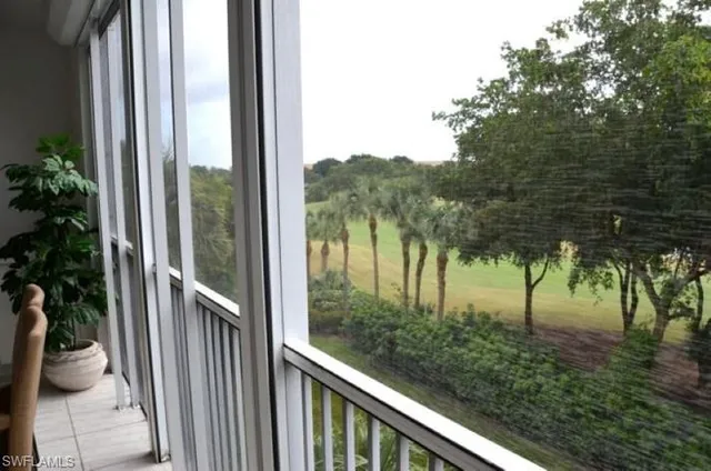 a view of a chairs and table in a balcony