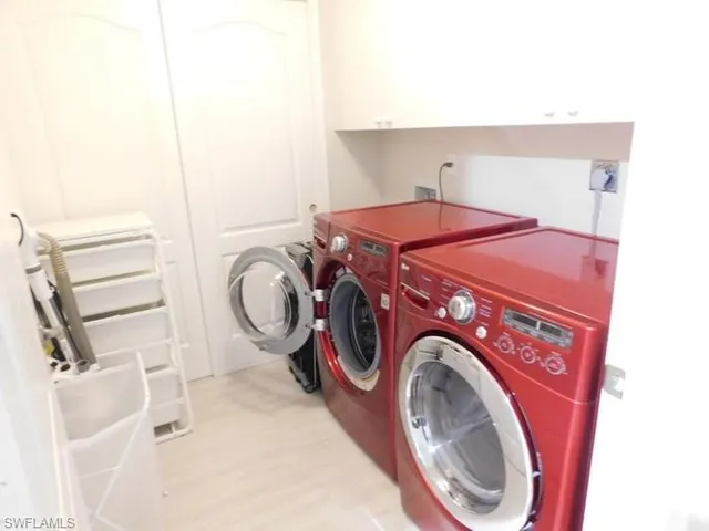a living room with furniture a rug and kitchen view