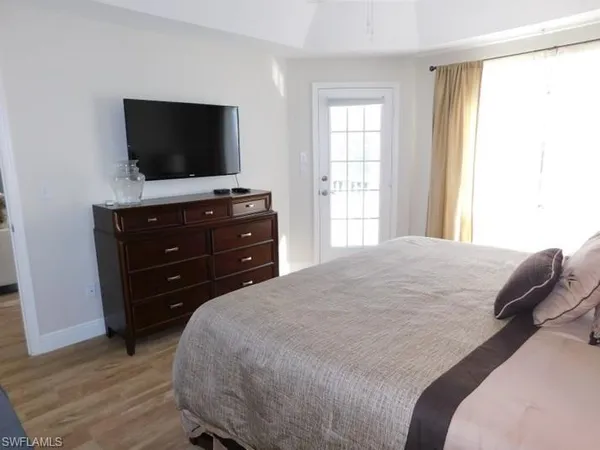 a bedroom with a bed and a flat screen tv