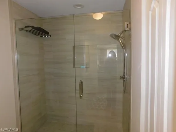 a bathroom with a glass shower door