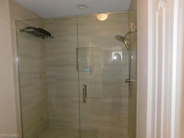 a bathroom with a glass shower door