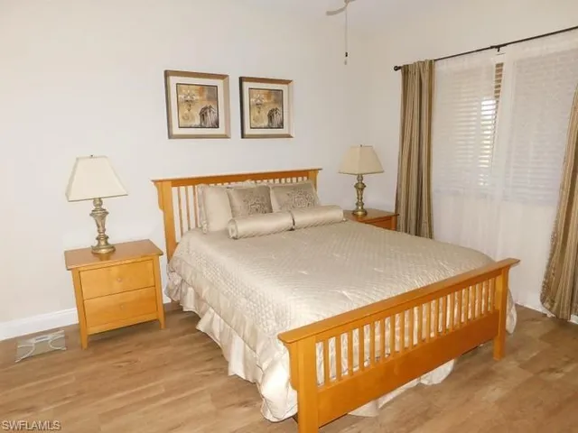 a large bed sitting in a bedroom next to a window
