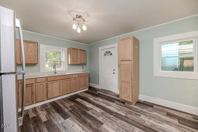 a kitchen with a refrigerator sink and cabinets