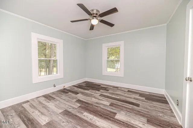a view of a room with wooden floor