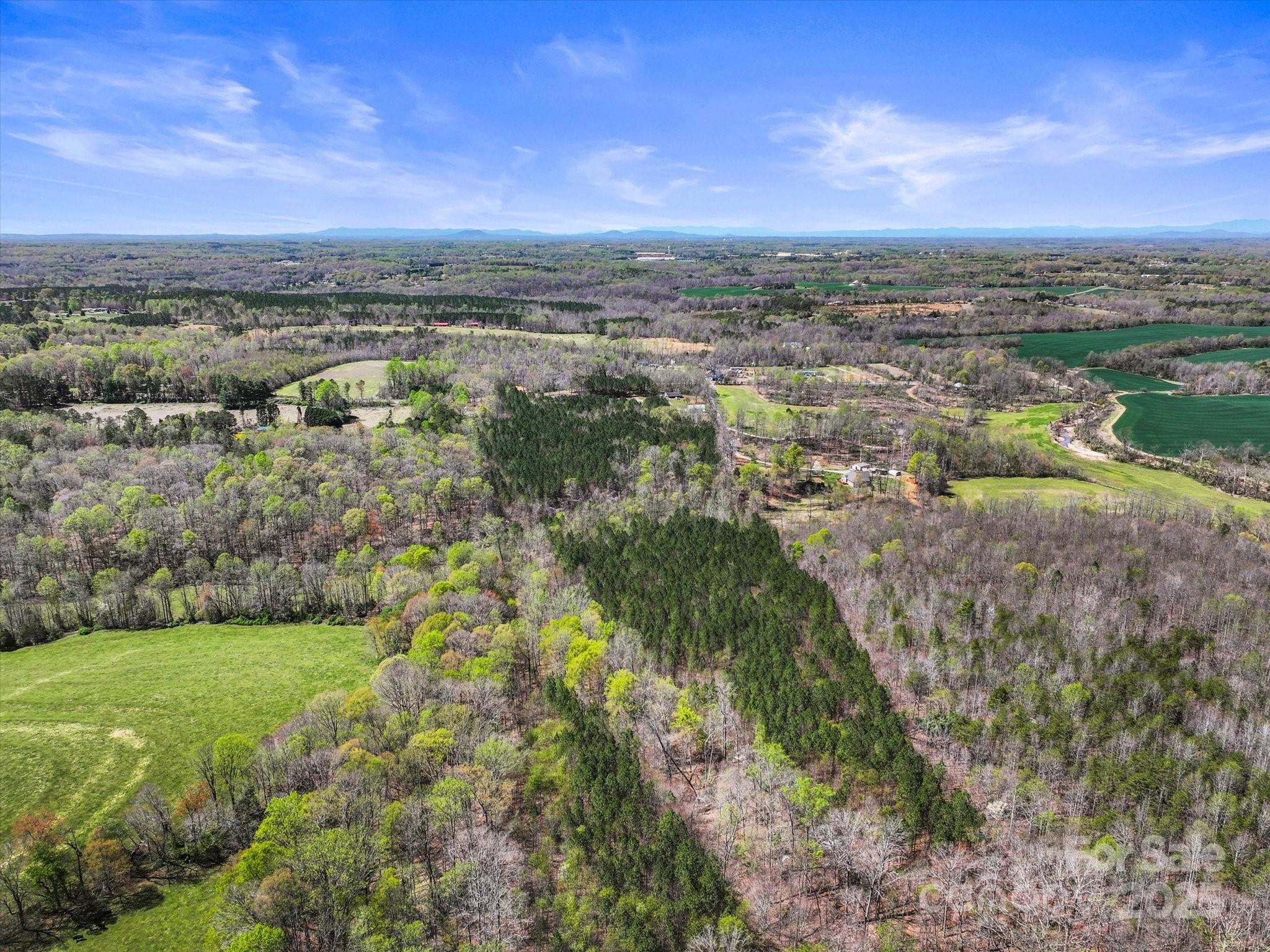 2122 Hewitt Road Claremont, NC 28610 - Photo 6 of 20 a view of a city with tall buildings in background
