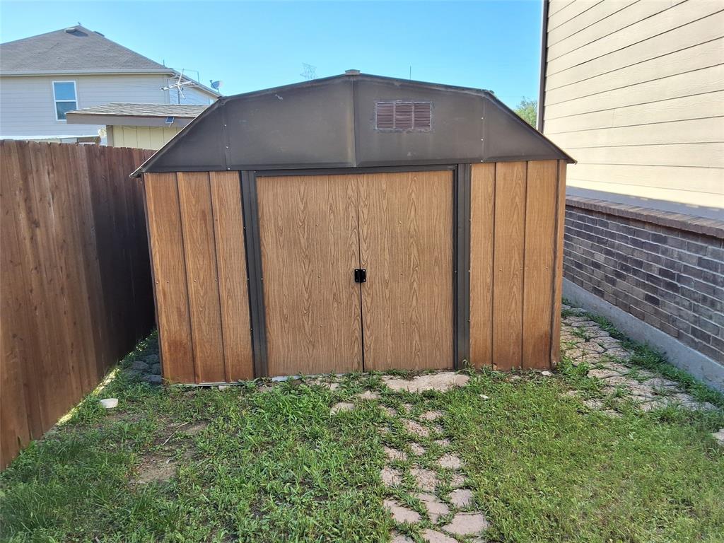 112 Hancock Street Venus, TX 76084 - Photo 25 of 25 Freestanding shed with wood-finish paneling and double doors