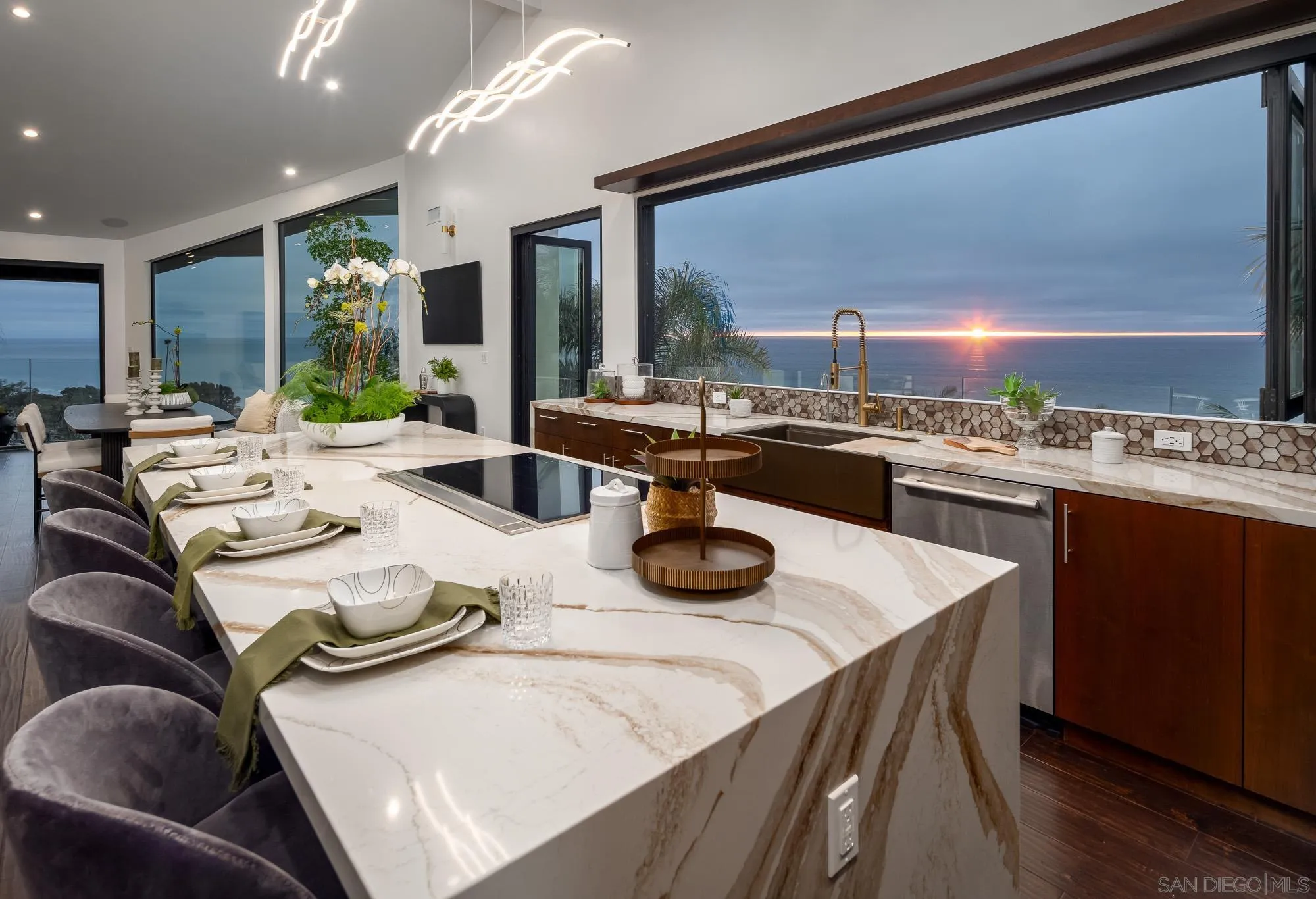a kitchen with a table chairs stove and wooden floor