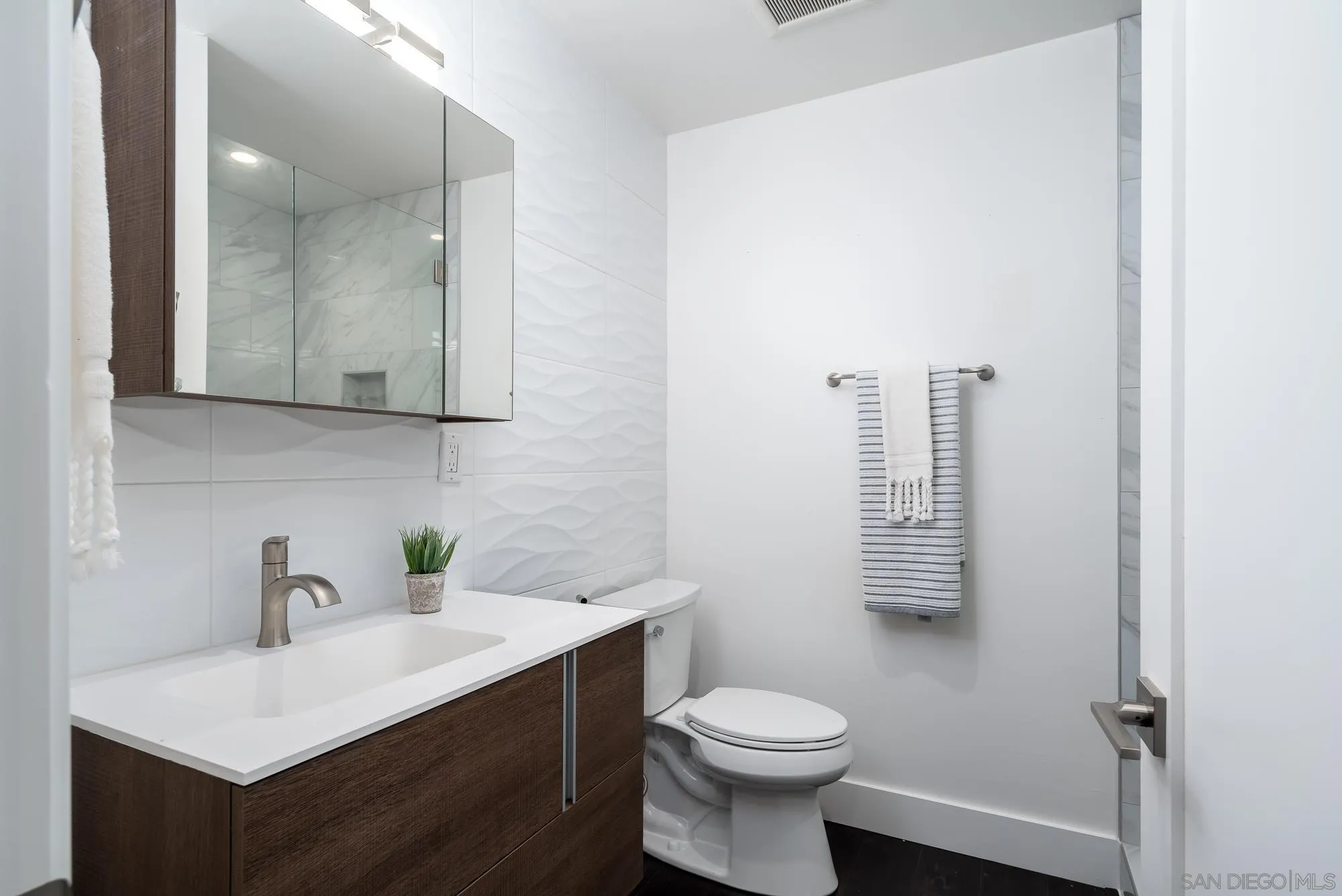 136 Verdi Avenue Cardiff, CA 92007 - Photo 25 of 27 a bathroom with a sink mirror vanity and toilet