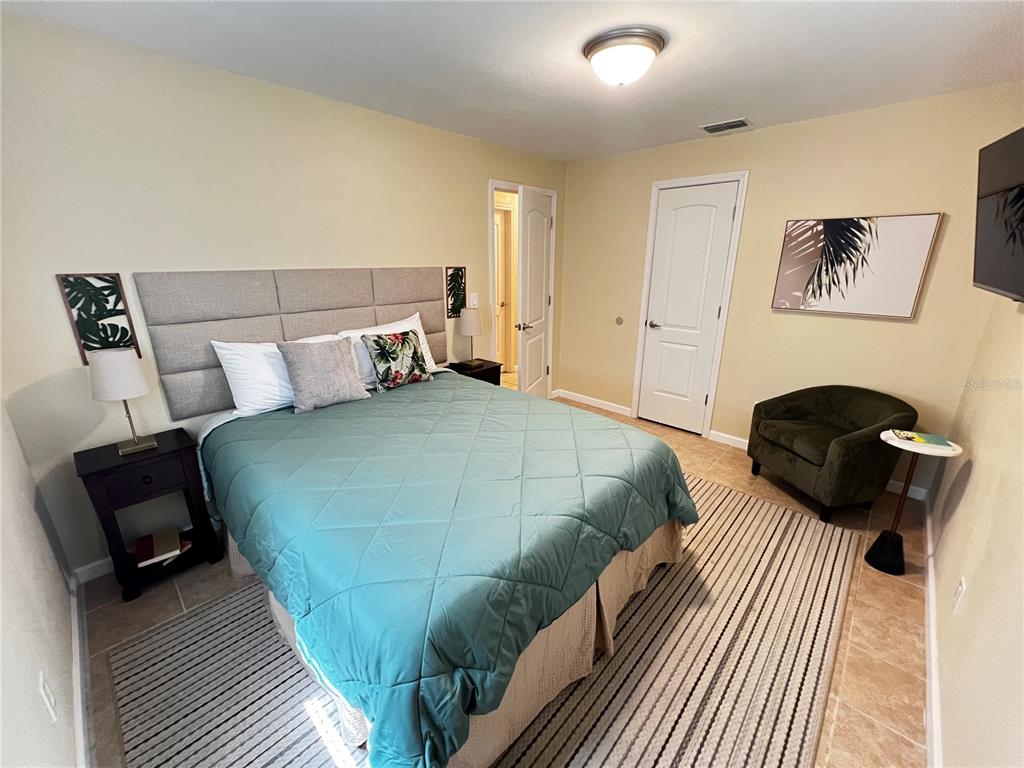 138 Woods Road San Mateo, FL 32187 - Photo 3 of 9 a bedroom with a bed and a painting on the wall