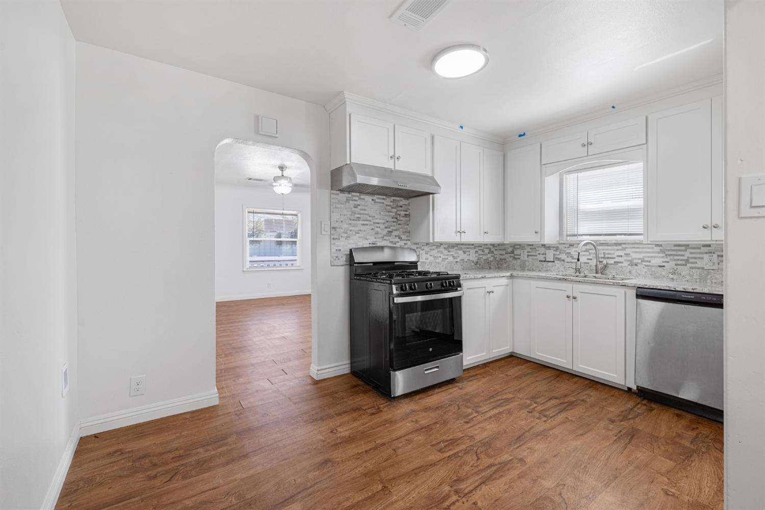 210 East Bush Street Lemoore, CA 93245 - Photo 11 of 42 a kitchen with granite countertop a stove and a refrigerator