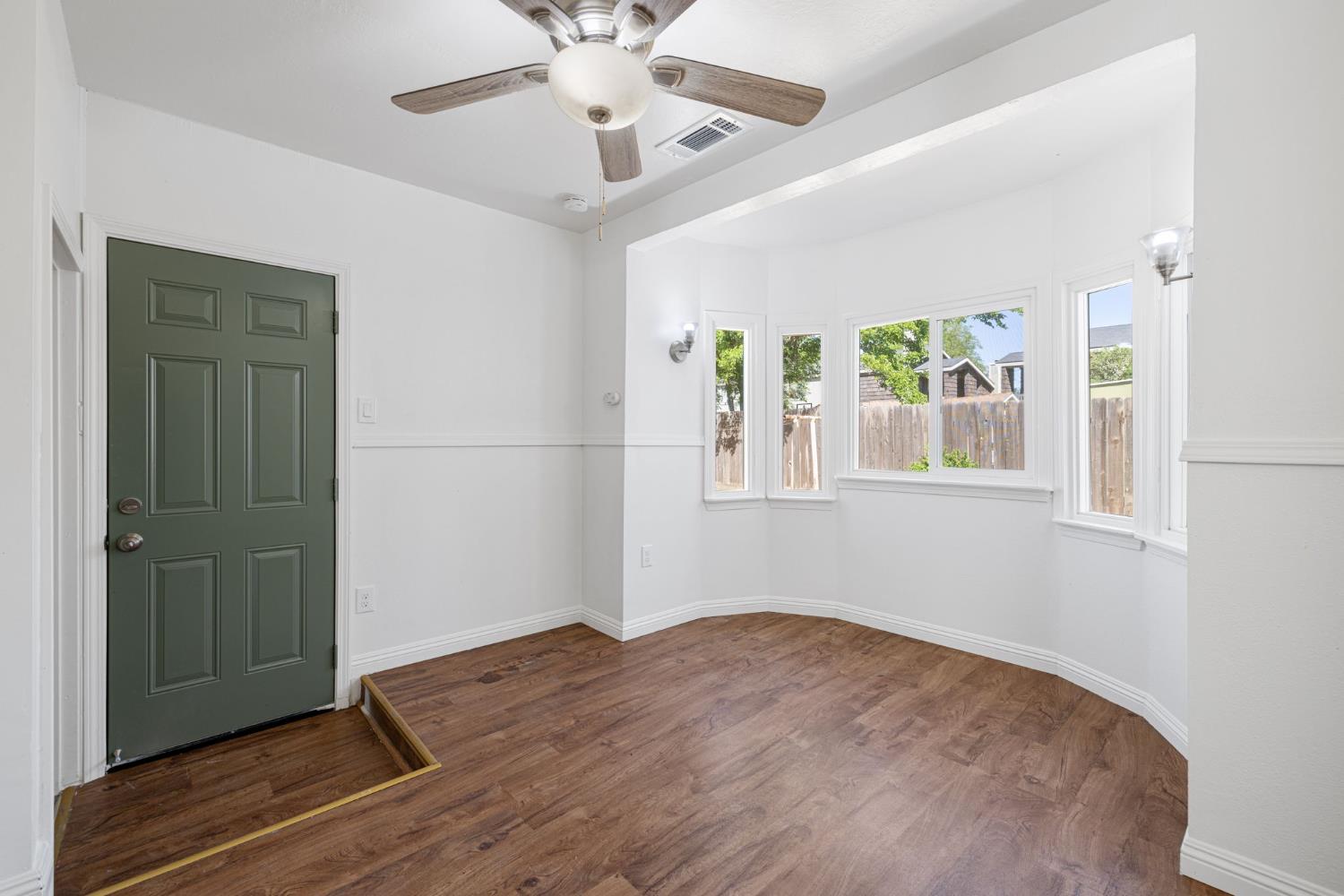 210 East Bush Street Lemoore, CA 93245 - Photo 18 of 42 a view of empty room with wooden floor and fan