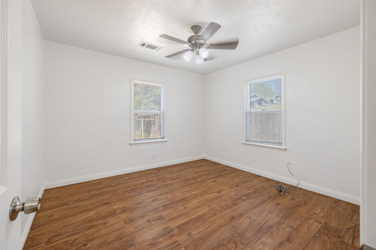 210 East Bush Street Lemoore, CA 93245 - Photo 28 of 42 a view of a room with window and ceiling fan