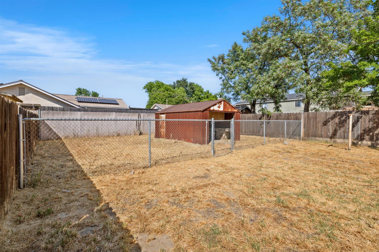 210 East Bush Street Lemoore, CA 93245 - Photo 32 of 42 a backyard of a house with a basket ball court