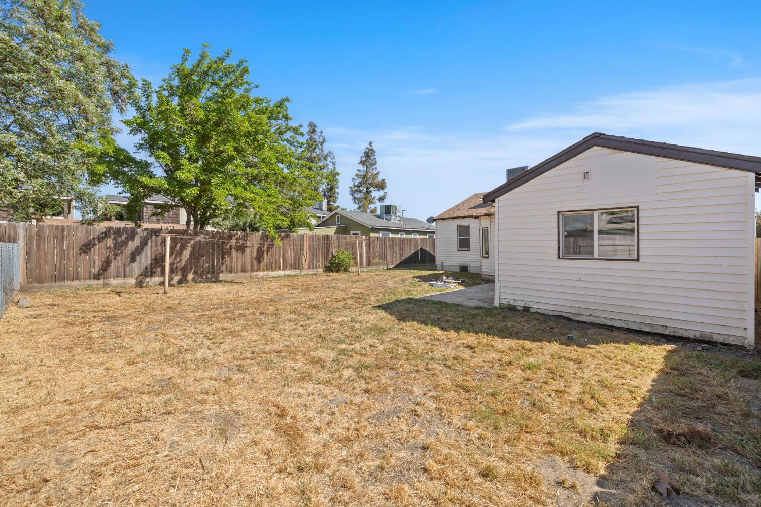 210 East Bush Street Lemoore, CA 93245 - Photo 36 of 42 a view of a house with a yard