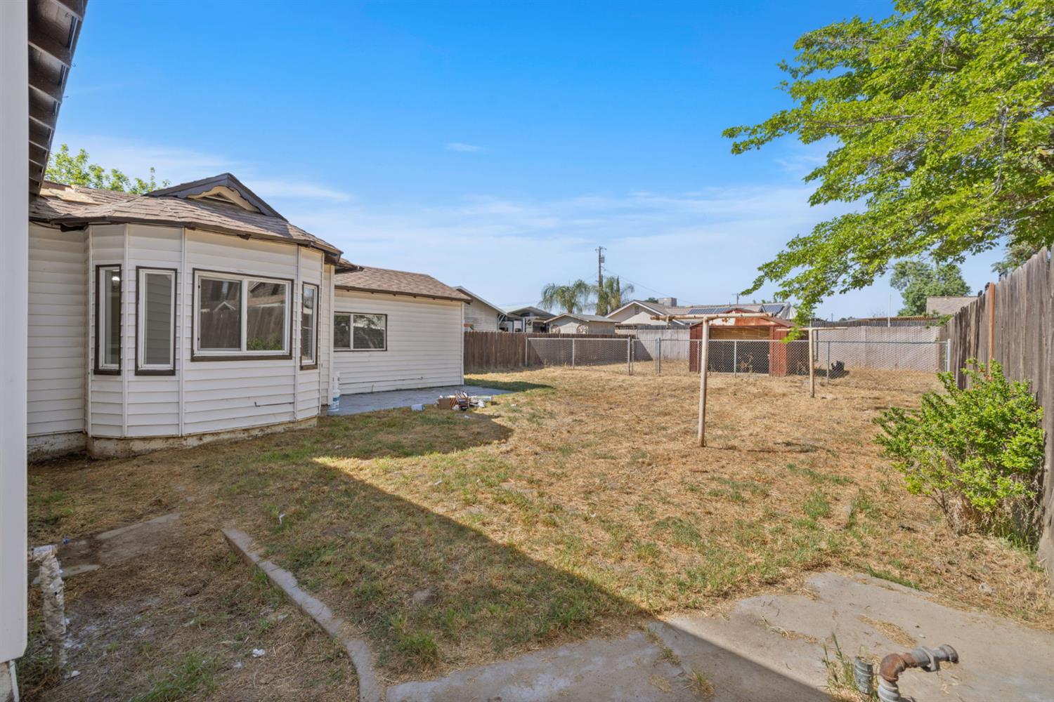 210 East Bush Street Lemoore, CA 93245 - Photo 38 of 42 a front view of a house with a yard