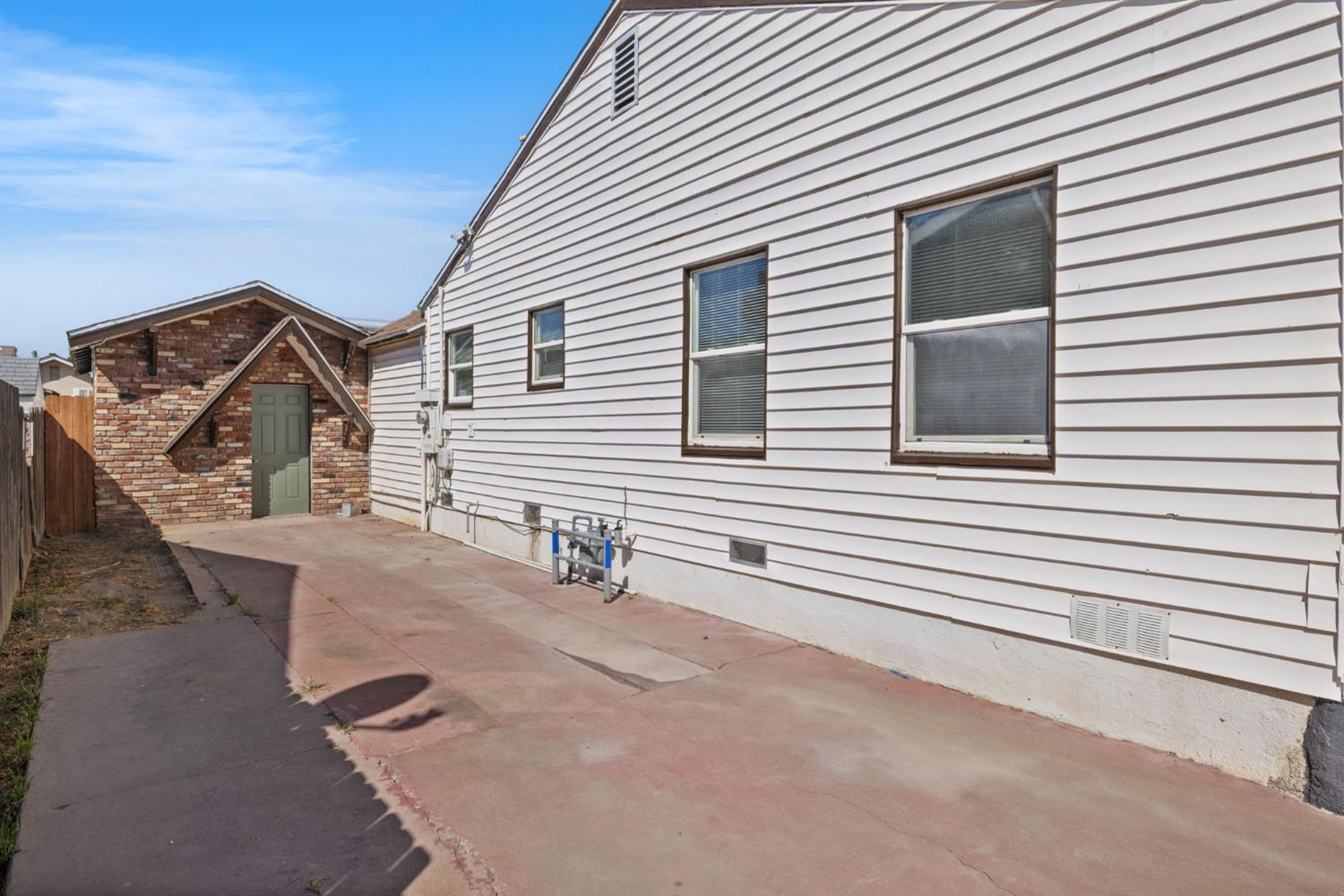 210 East Bush Street Lemoore, CA 93245 - Photo 4 of 42 a view of a house with a yard and garage