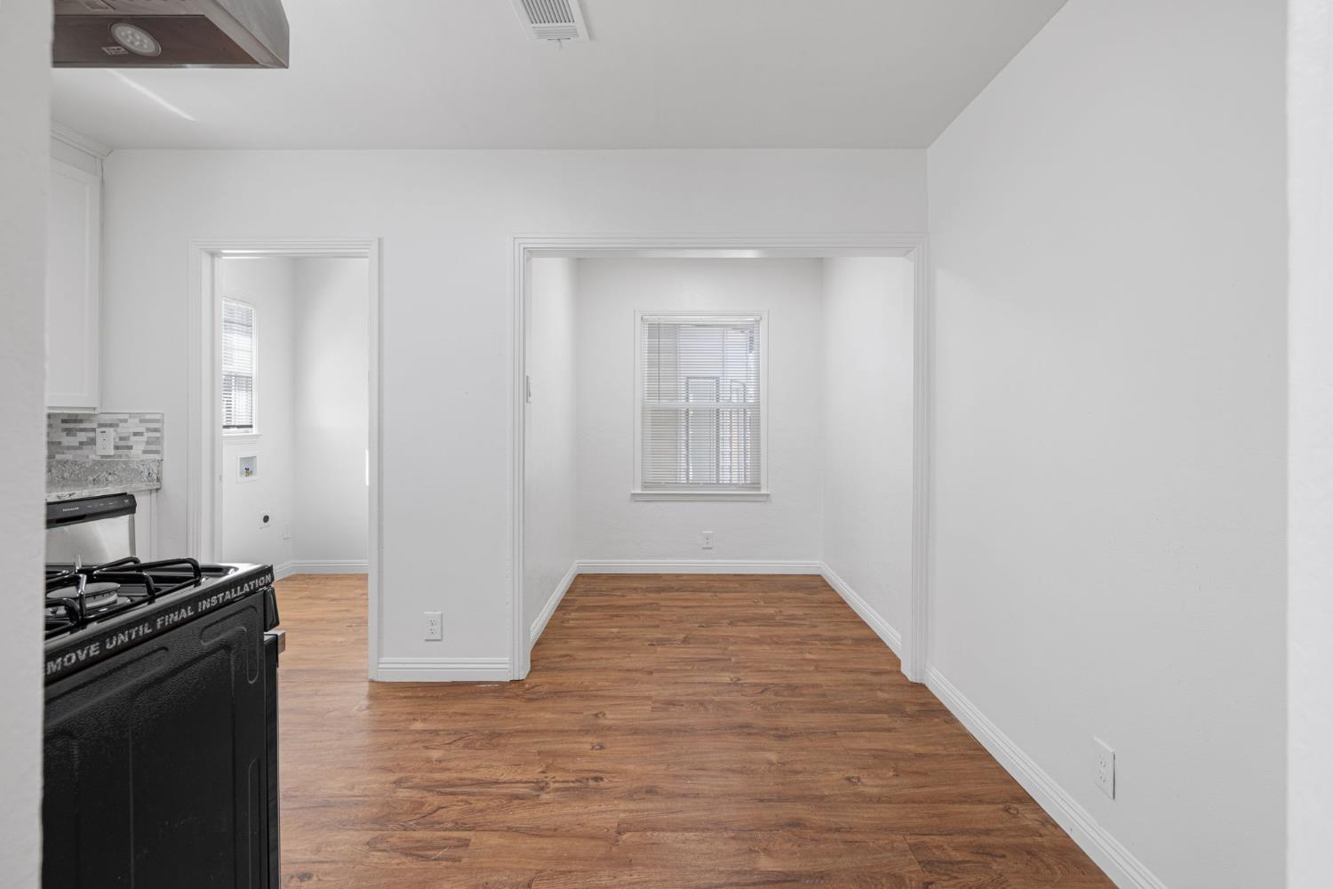 210 East Bush Street Lemoore, CA 93245 - Photo 9 of 42 a view of a kitchen from the hallway