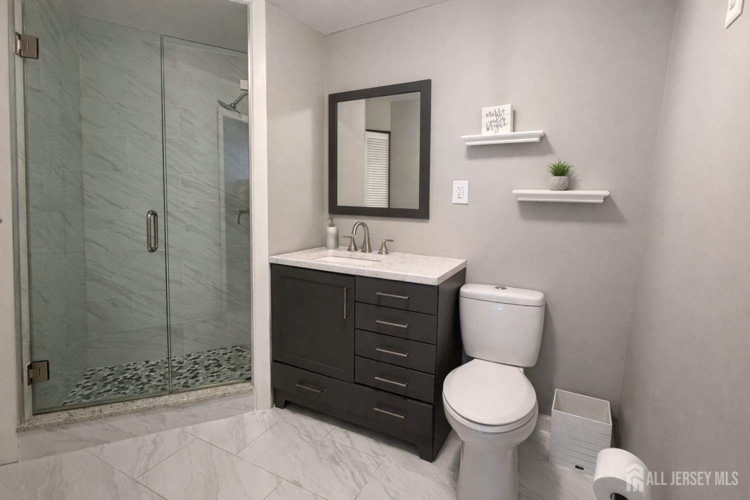 618 Lee Street Perth Amboy, NJ 08861 - Photo 19 of 24 a bathroom with a toilet a sink and shower