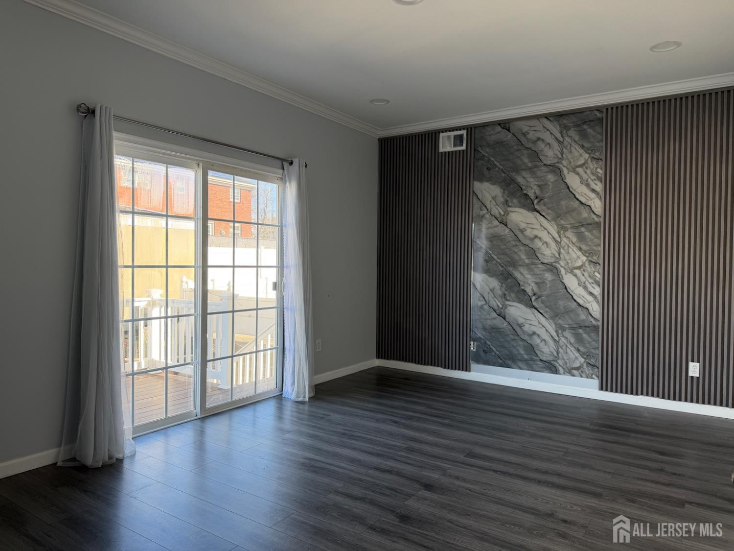 618 Lee Street Perth Amboy, NJ 08861 - Photo 9 of 24 a view of an empty room with wooden floor and a window