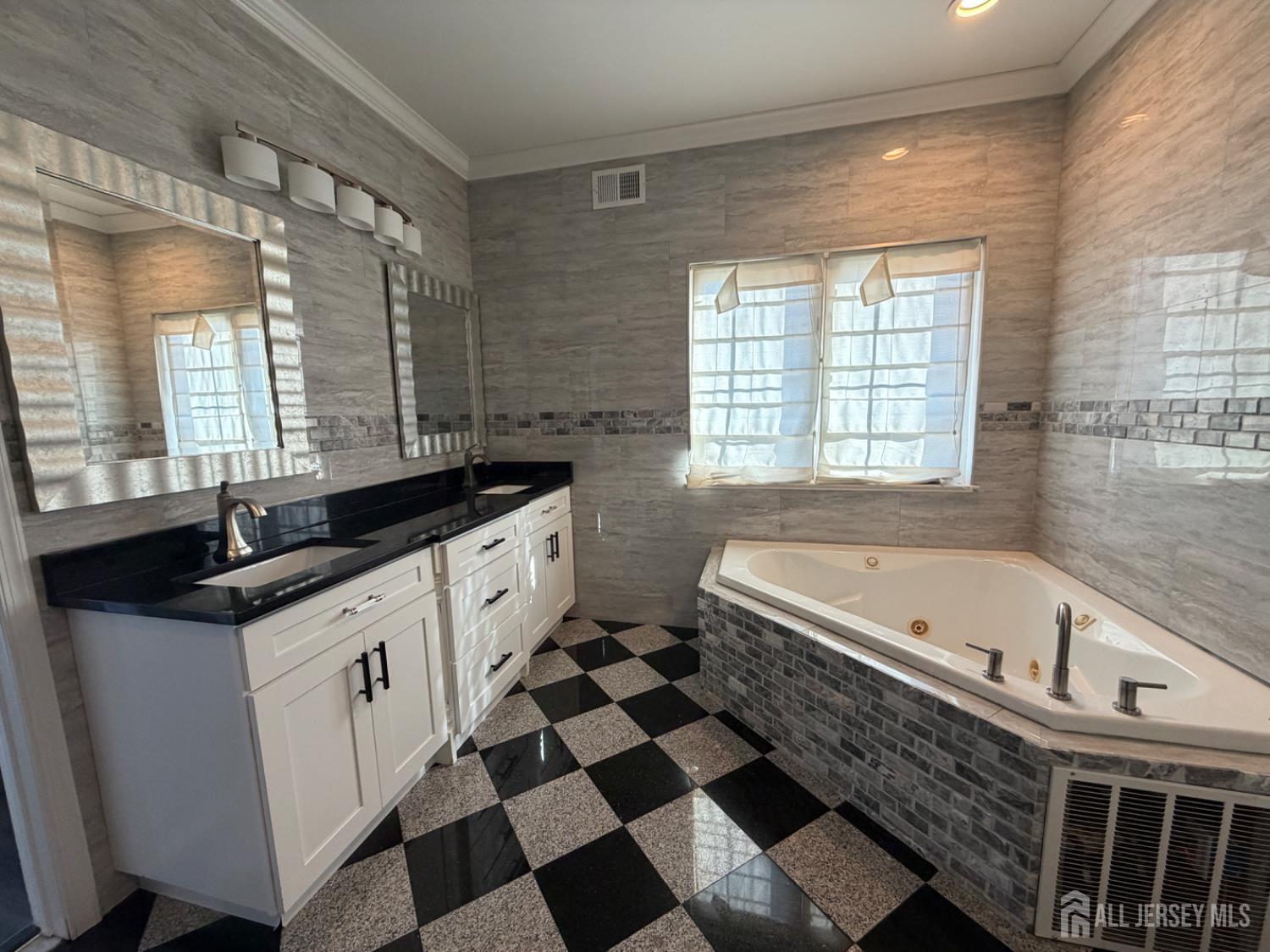 618 Lee Street Perth Amboy, NJ 08861 - Photo 10 of 24 a spacious bathroom with a granite countertop sink and a bathtub