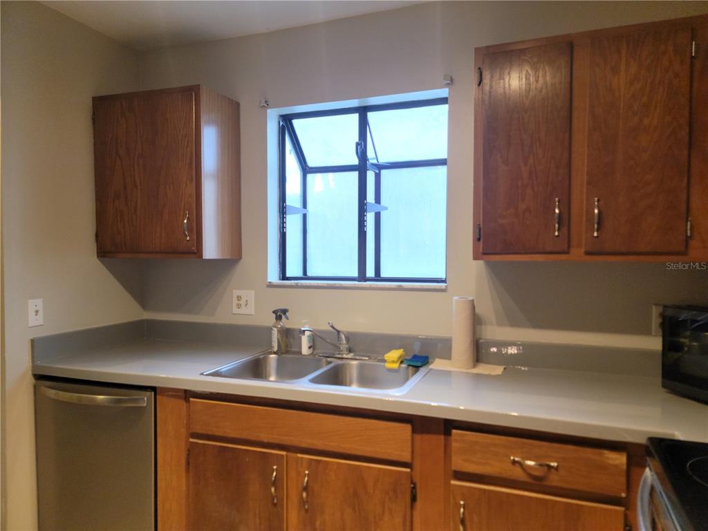 2300 Southwest 43rd Street, Unit I1 Gainesville, FL 32607 - Photo 11 of 15 a kitchen with a sink cabinets and window