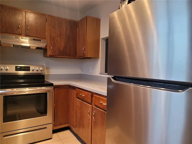 a kitchen with stainless steel appliances a stove and a refrigerator
