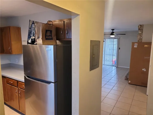 a view of a refrigerator and an empty room
