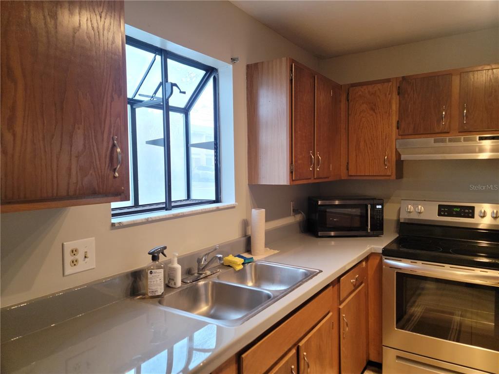 2300 Southwest 43rd Street, Unit I1 Gainesville, FL 32607 - Photo 3 of 15 a kitchen with a sink stove and cabinets