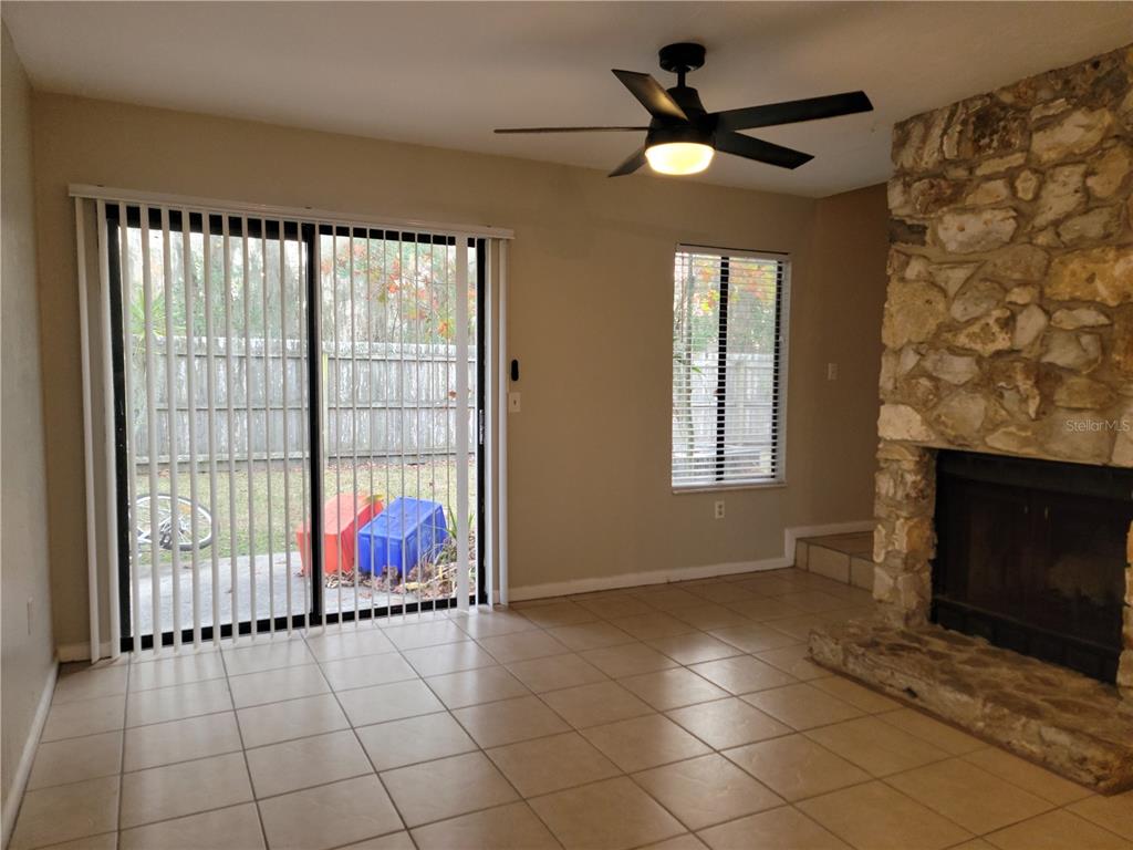 2300 Southwest 43rd Street, Unit I1 Gainesville, FL 32607 - Photo 8 of 15 a living room with a fireplace furniture and a large window