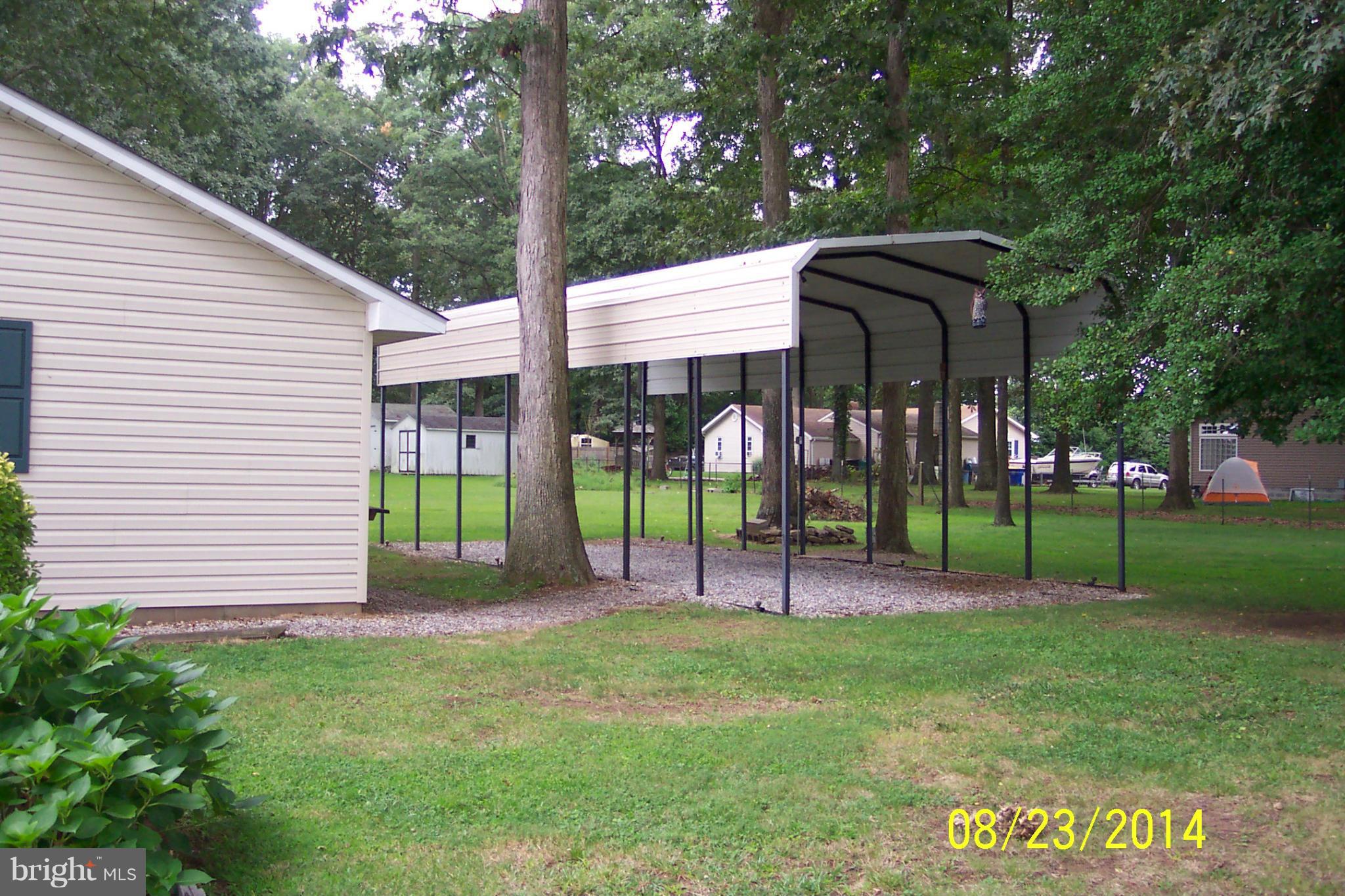 5884 Cloverdale Road Hurlock, MD 21643 - Photo 6 of 26 a view of a park with of a house and a large tree