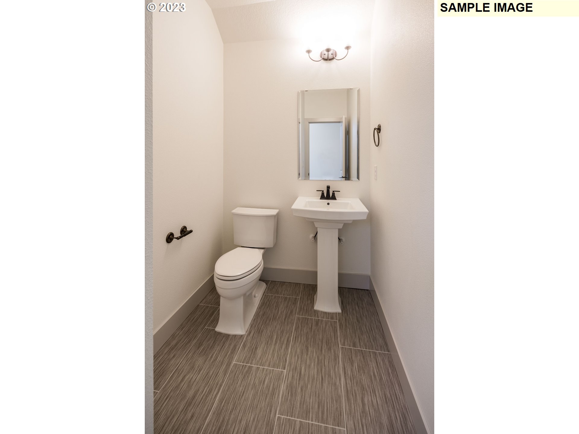 1016 Northwest 178th Street Ridgefield, WA 98642 - Photo 7 of 13 a bathroom with a sink a toilet and a mirror