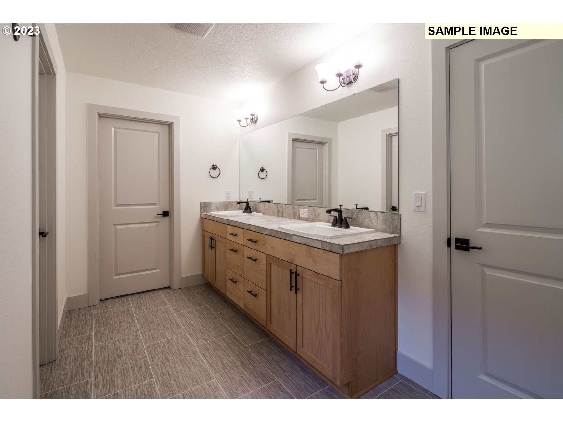 1016 Northwest 178th Street Ridgefield, WA 98642 - Photo 10 of 13 a bathroom with a double vanity sink and mirror