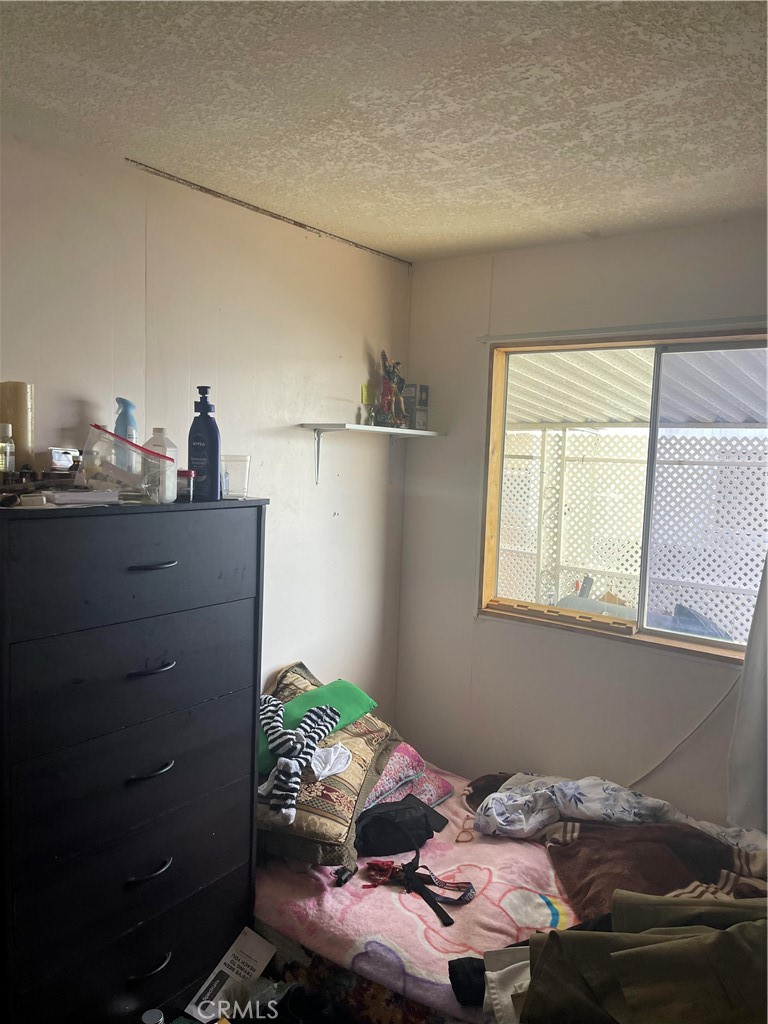 26611 Nudgent Street, Unit 28 Boron, CA 93516 - Photo 6 of 12 a bedroom with a bed and a window