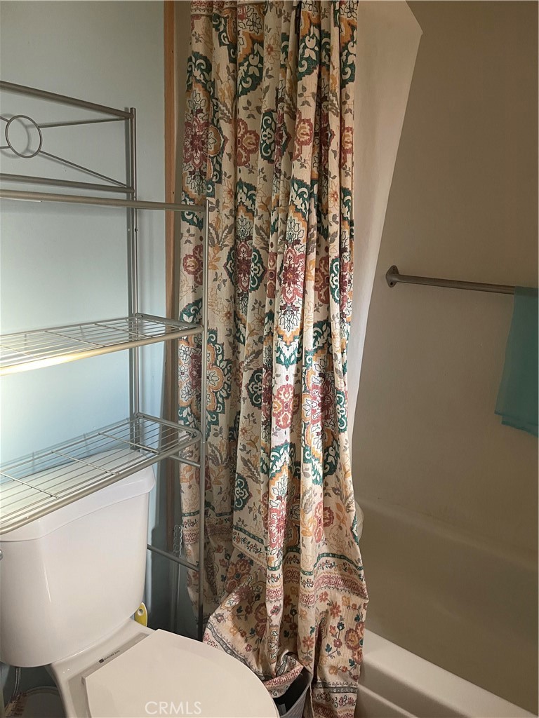 26611 Nudgent Street, Unit 28 Boron, CA 93516 - Photo 10 of 12 a white toilet sitting next to a shower