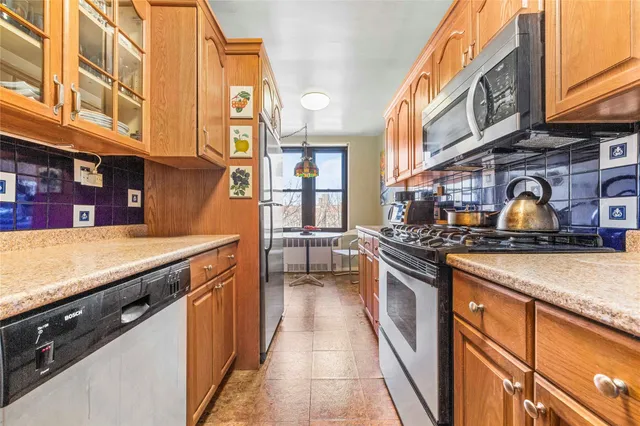 a kitchen with stainless steel appliances granite countertop a stove and a sink