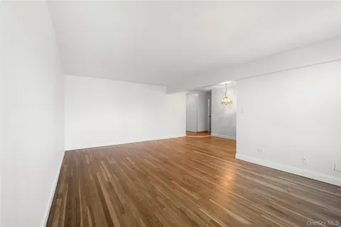 a view of an empty room and wooden floor
