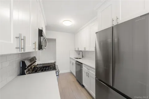 a kitchen with stainless steel appliances a refrigerator sink and stove